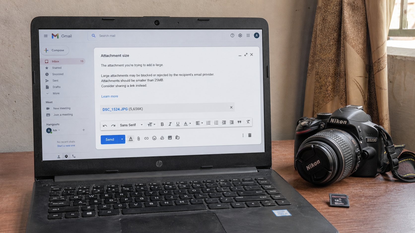 A laptop with a large camera photo and a smaller copy for email.