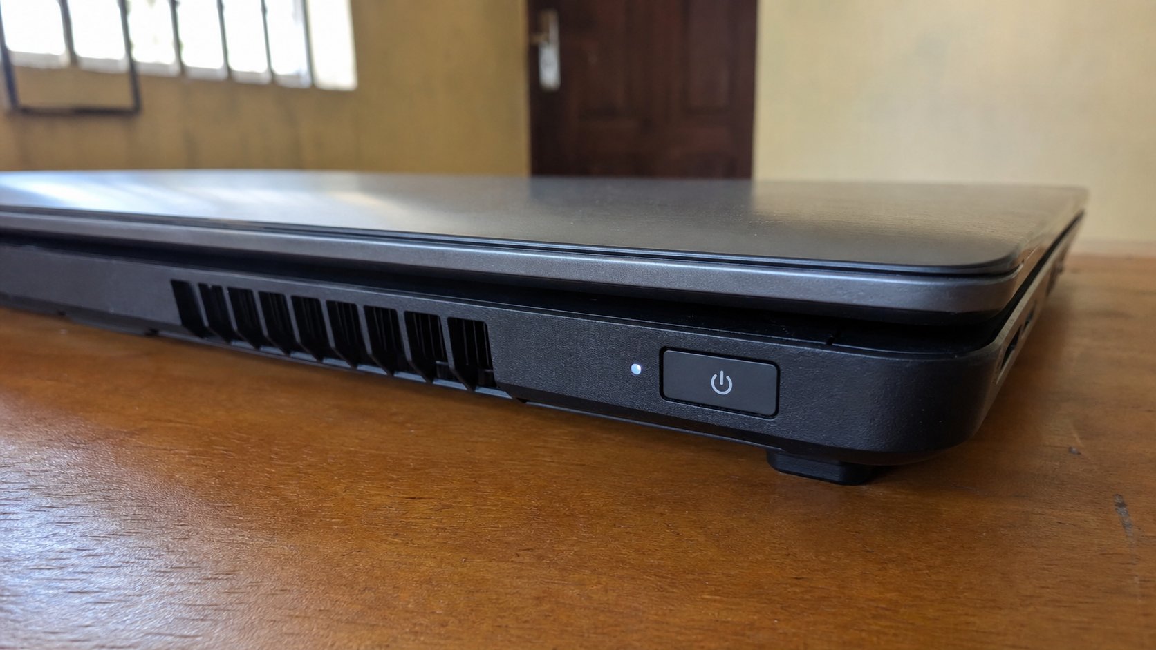 Close-up of a laptop power button and the edge of the lid.