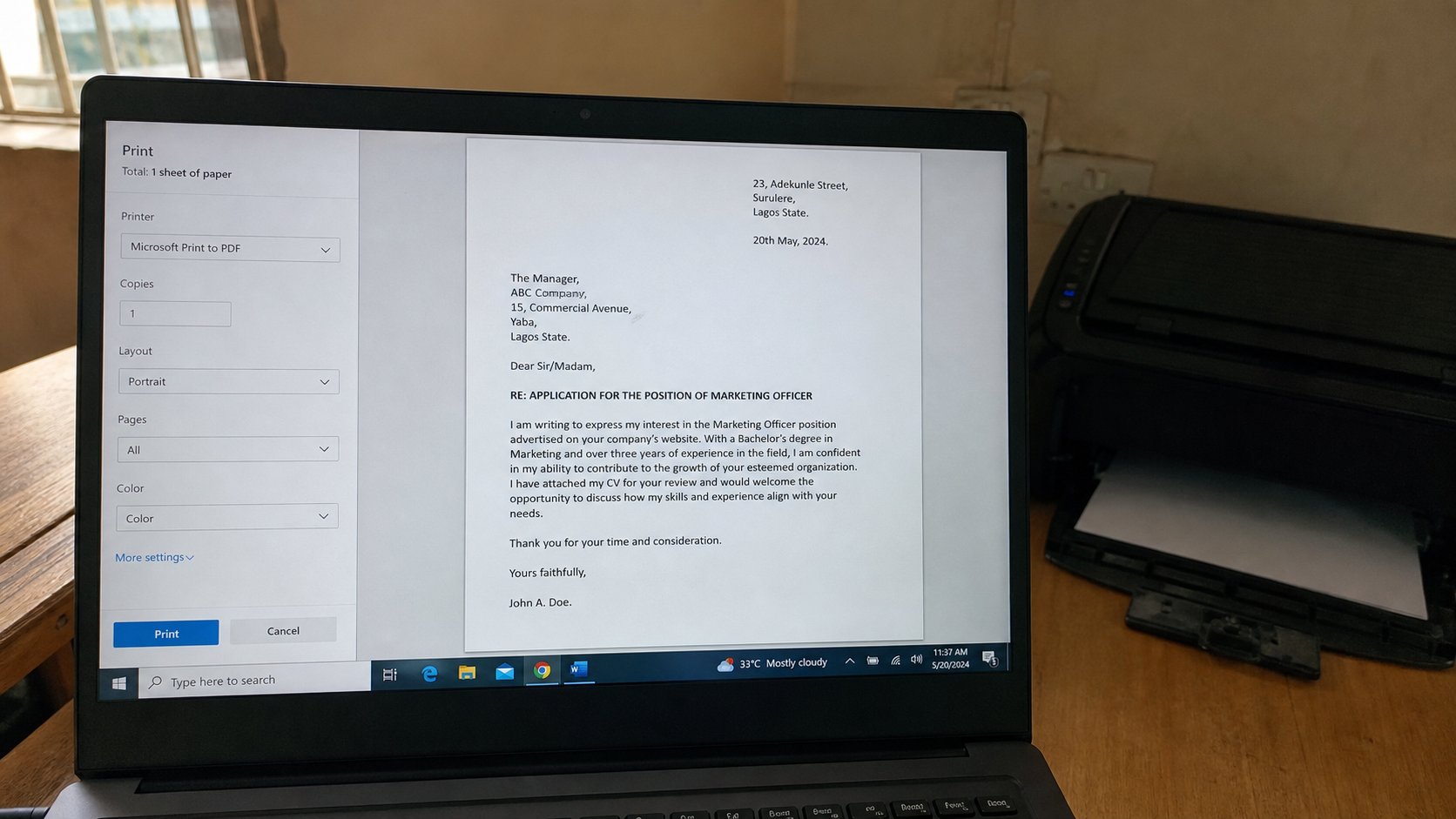 A laptop screen showing a print preview of a one-page letter, a printer behind it.