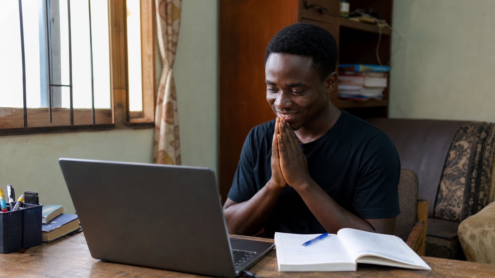 A learner looking at a recovered letter on a laptop.